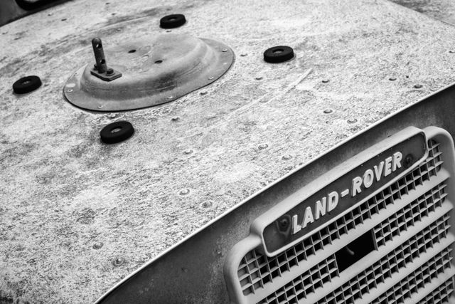 Detail of the hood of an old Land Rover covered in dirt and grime.