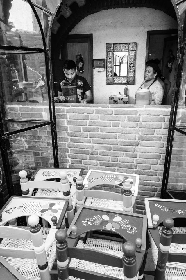 Two people preparing food at Fonda Carmelita in La Ciudadela, Mexico City.