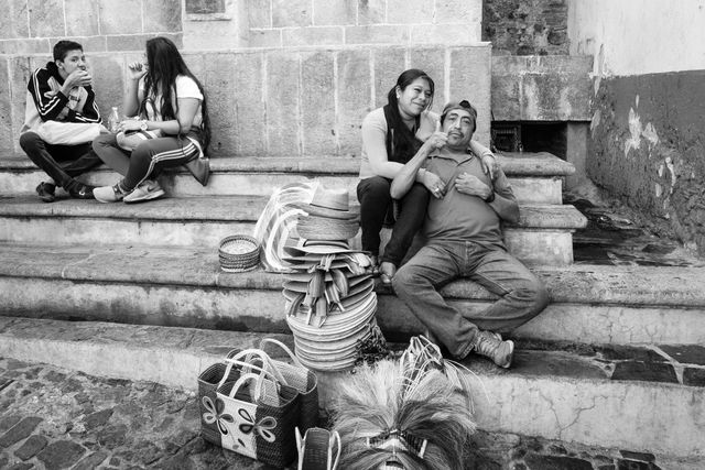 A man sitting with his girlfriend, giving a thumbs up.