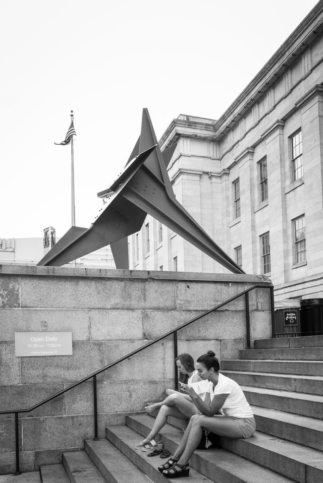 People sitting on the steps outside the National Portrait Gallery in DC.