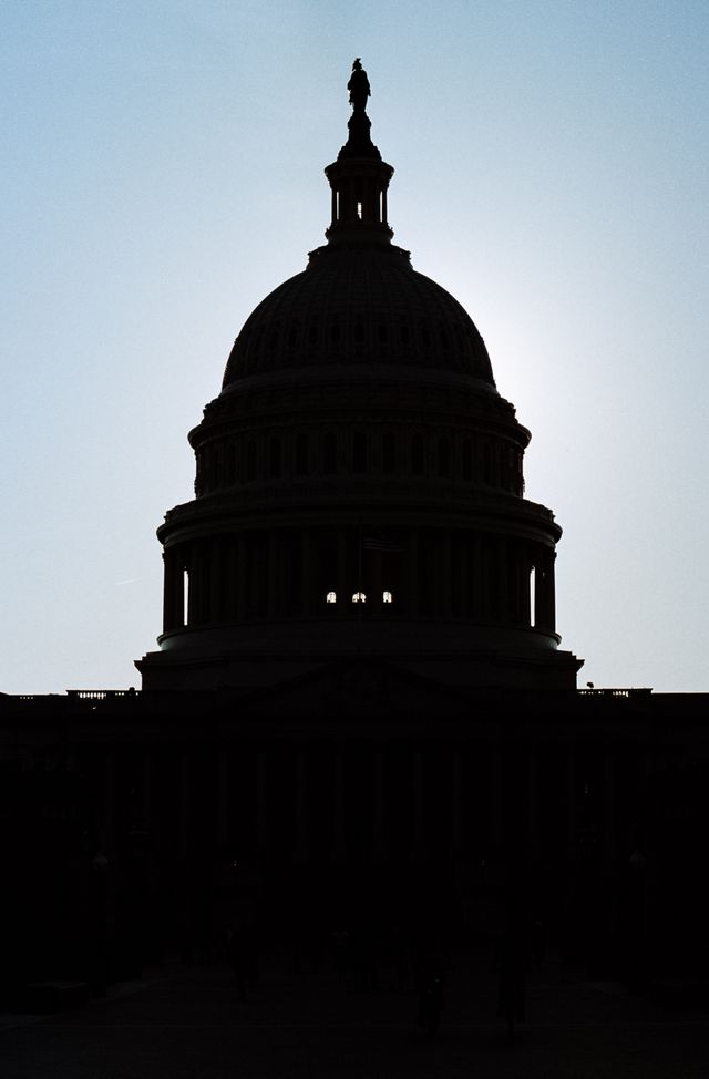 Silhouette of the United States Capitol, at sunset.