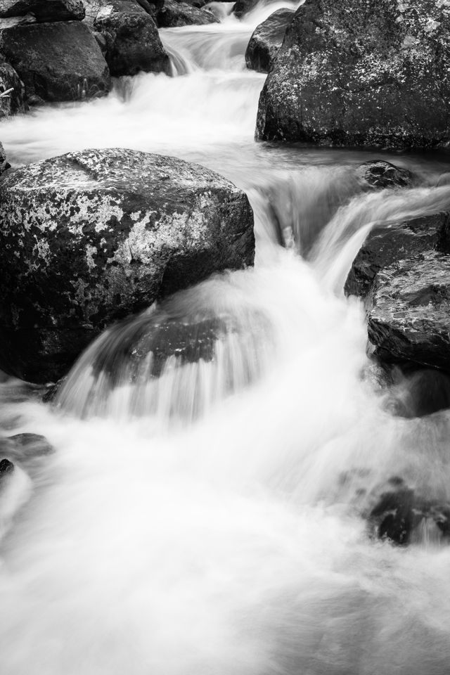 The waters of Taggart Creek running around some boulders.