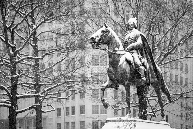 Equestrian statue of Kazimierz Pułaski at Freedom Plaza, covered in snow.