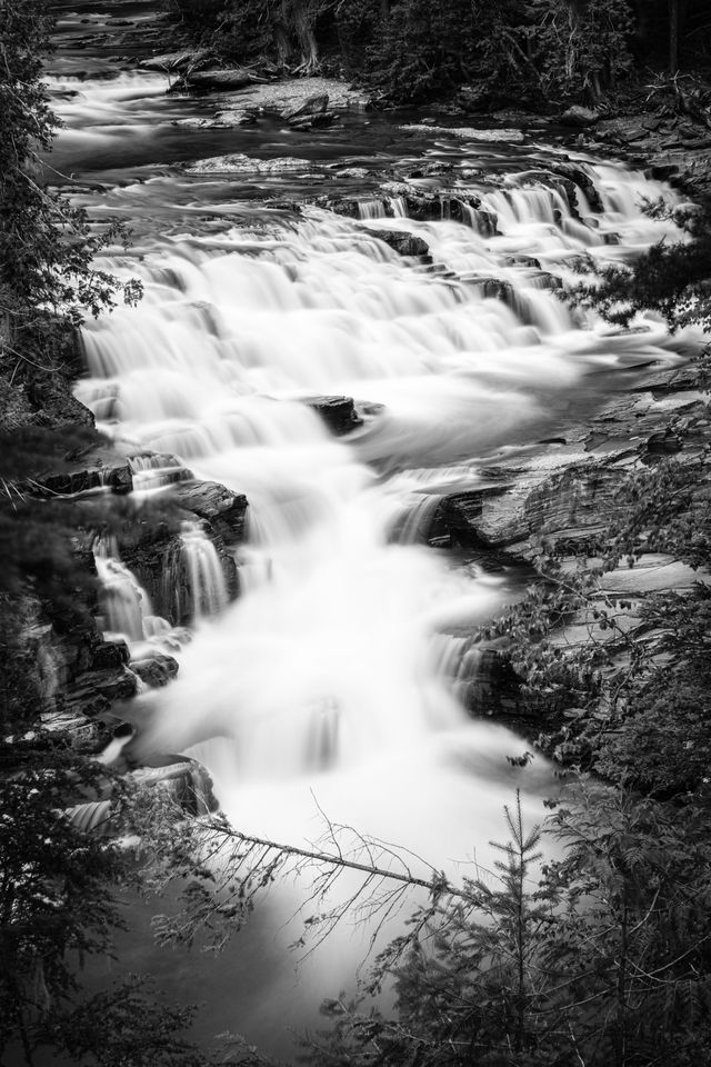 A long exposure photograph of McDonald Falls, as seen from the turnout on Going-to-the-Sun Road.