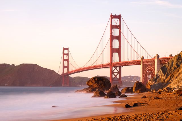 The Golden Gate bridge bathed in golden light at sunset, from Marshall's Beach.