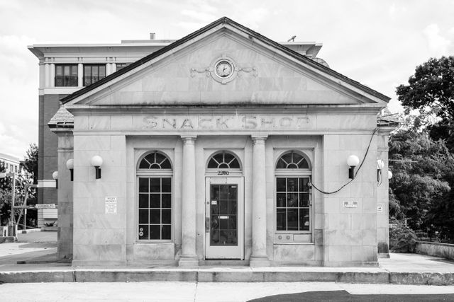 The gas station formerly known as the Embassy Gulf Service Station in Dupont Circle, with the faded remains of the Snack Shop sign under its pediment.