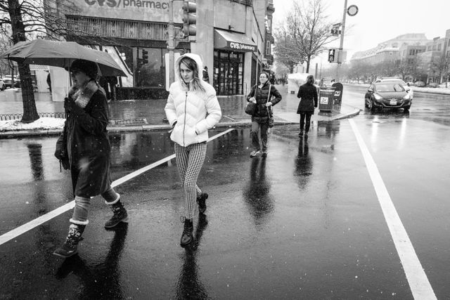 A group of women crossing the street near the Eastern Market Metro Station.