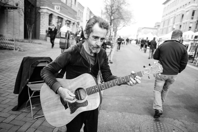 John, playing the guitar at Eastern Market.