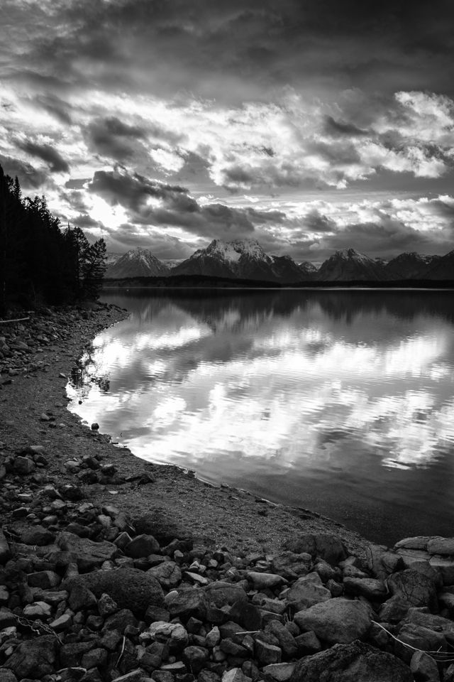 The shore of Jackson Lake, with Mount Moran in the background, at sunset.