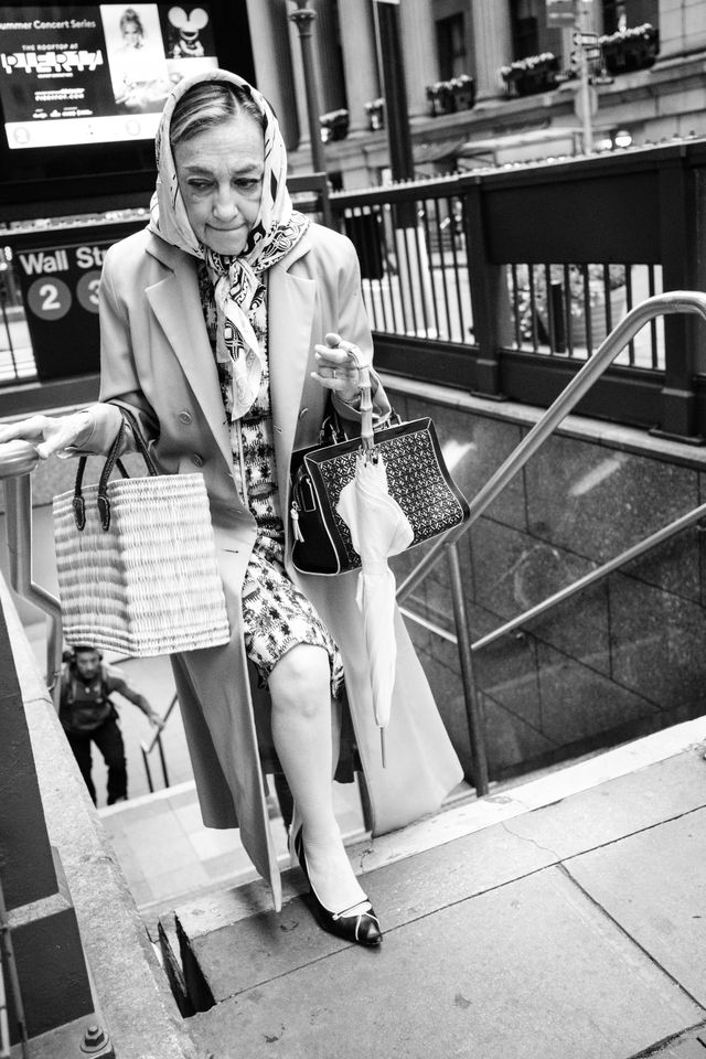 A woman in a headscarf leaving the Wall Street subway station in New York.