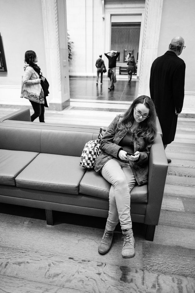 Kate, sitting on a bench at the National Gallery of Art.