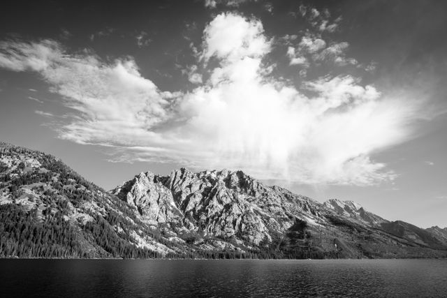 Symmetry Spire, Mount Saint John, and Mount Moran, seen under clouds from across Jenny Lake.