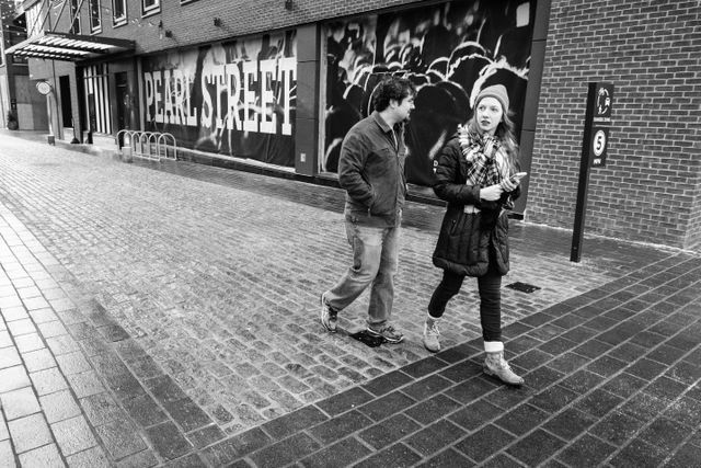 Two people walking on Pearl Street at The Wharf, in Washington, DC.