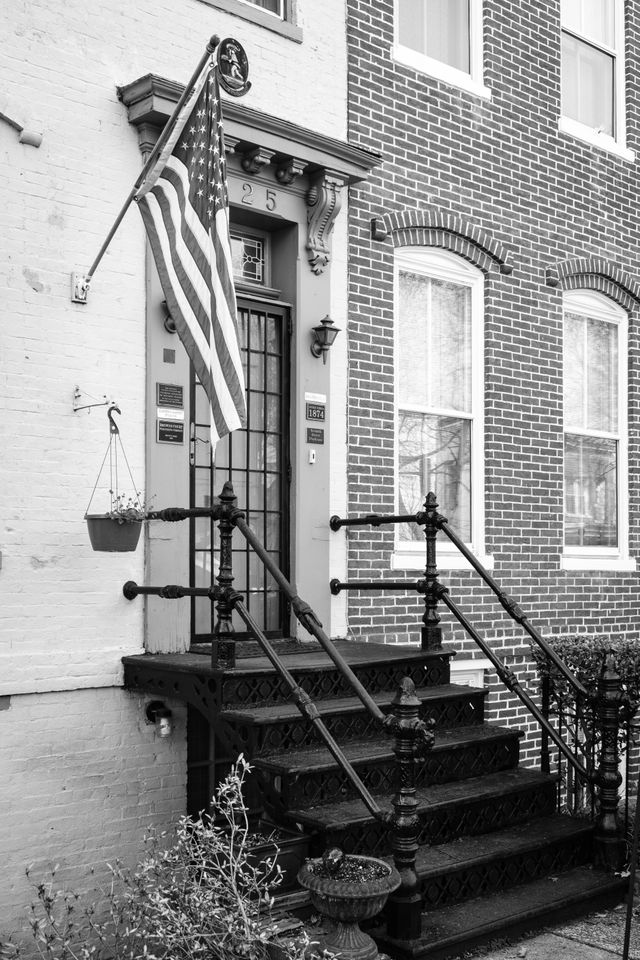 A flag next to a door in a Capitol Hill rowhouse.