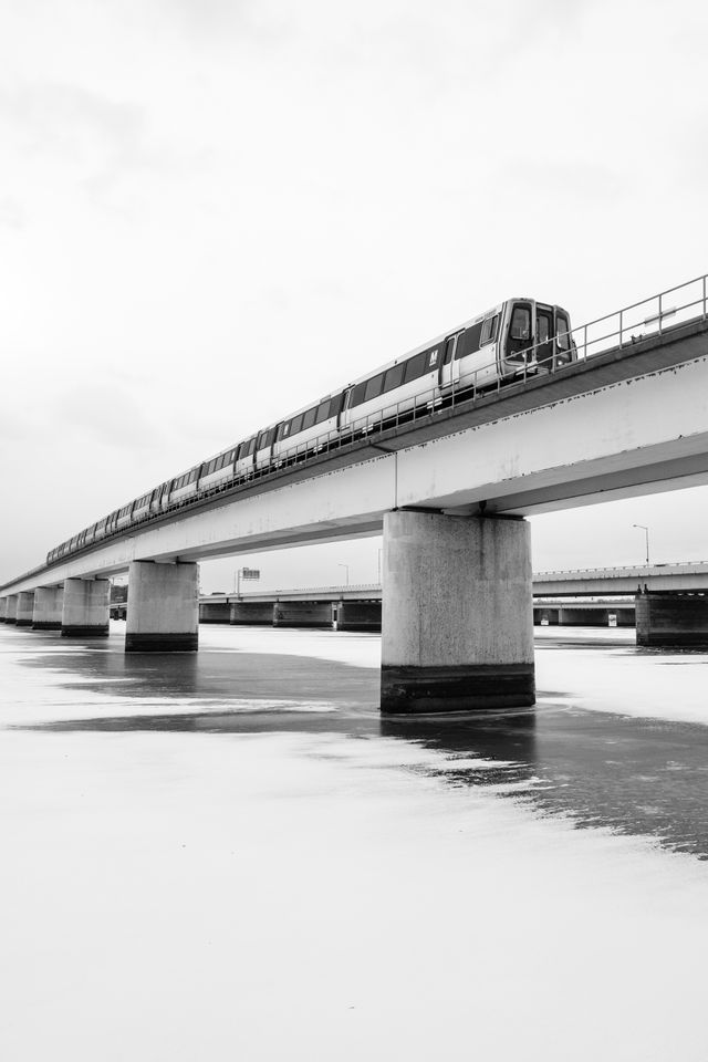 A yellow line Metro train crossing the frozen Potomac river.