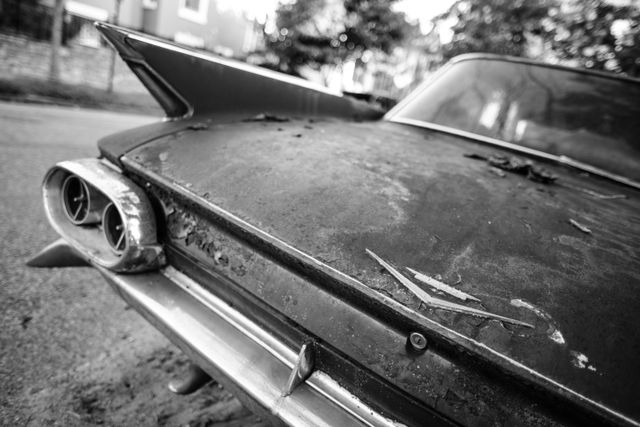 Trunk and left tailfin of a rusted 1960s Cadillac de Ville parked on 9th Street & K Street NE in Washington, DC.